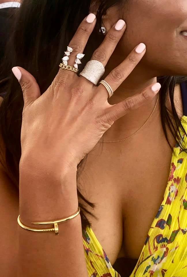 Rings and layered jewelry styled on hand