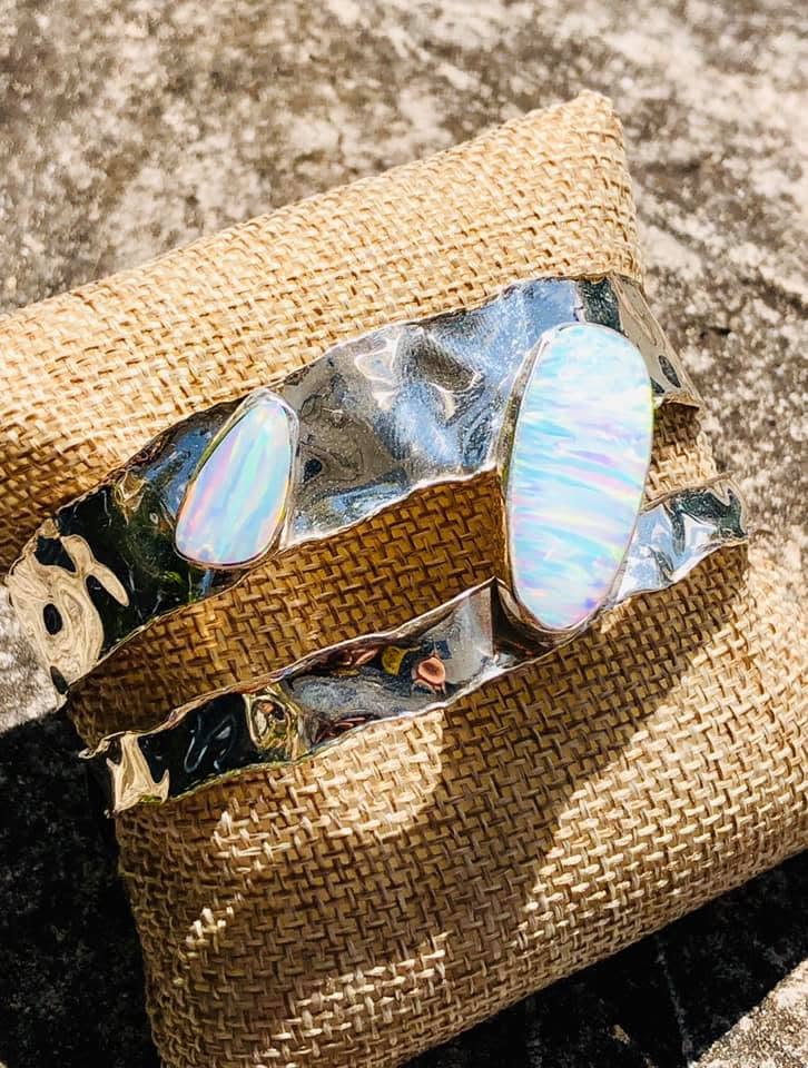 Sculptural bracelet with iridescent stones on woven straw