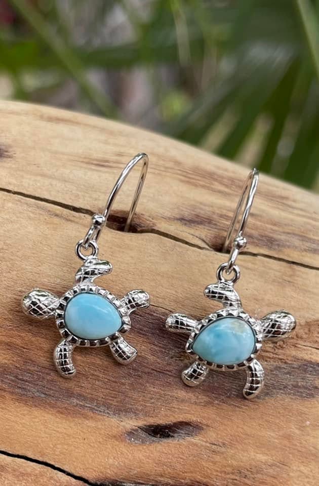 Turquoise sea turtle earrings on wood